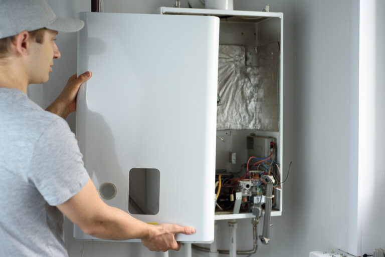 A,Man,Checks,A,Gas,Boiler,For,Home,Heating.,Maintenance