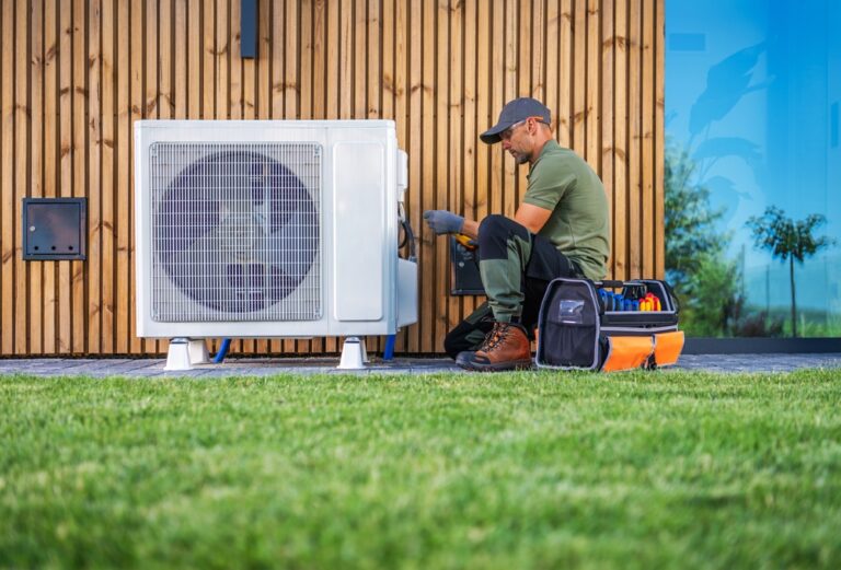 A,Technician,Is,Servicing,An,Air,Conditioning,Unit,Located,Beside