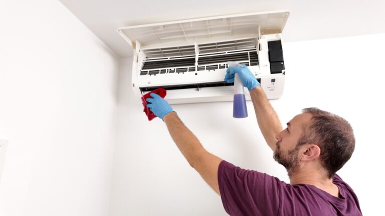 Man,Cleaning,And,Maintaining,Air,Condition,Unit,At,Home.