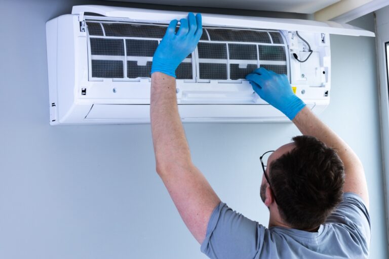 Man,In,Grey,Shirt,And,Blue,Gloves,Performing,Maintenance,On